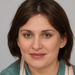 Joyful white adult female with medium  brown hair and brown eyes