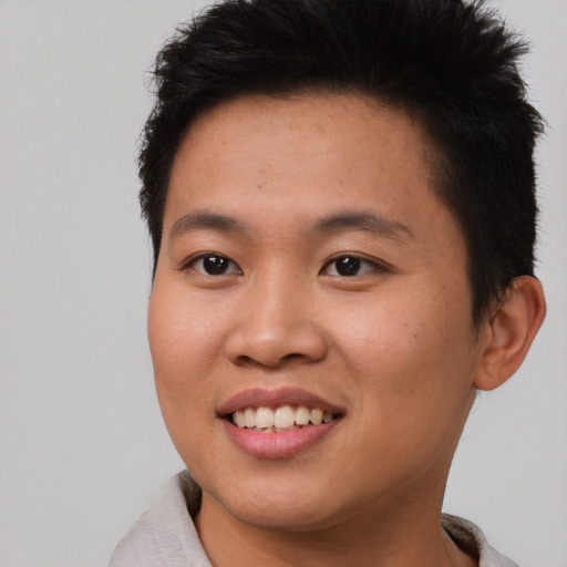 Joyful asian young-adult male with short  brown hair and brown eyes