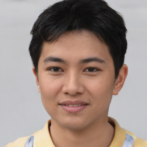 Joyful asian young-adult male with short  black hair and brown eyes
