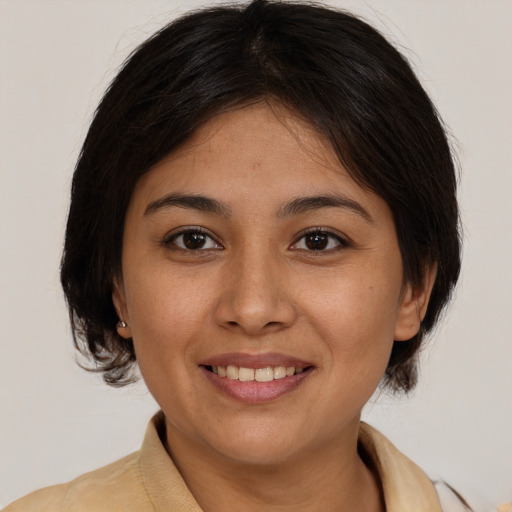 Joyful latino young-adult female with medium  brown hair and brown eyes