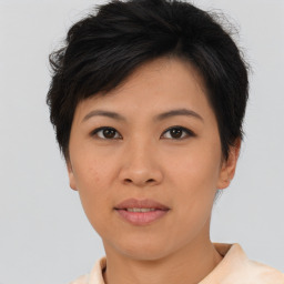 Joyful asian young-adult female with short  brown hair and brown eyes