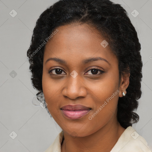 Joyful black young-adult female with long  brown hair and brown eyes