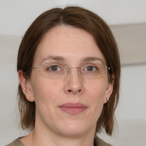 Joyful white adult female with medium  brown hair and grey eyes