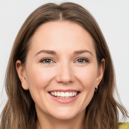 Joyful white young-adult female with long  brown hair and brown eyes