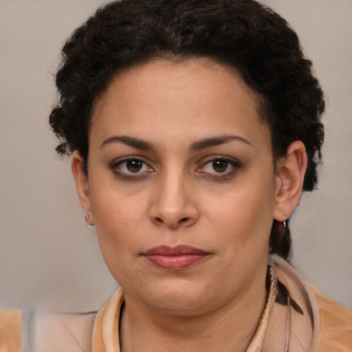 Joyful latino young-adult female with short  brown hair and brown eyes