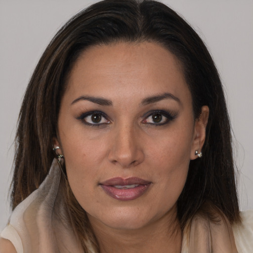 Joyful latino young-adult female with long  brown hair and brown eyes
