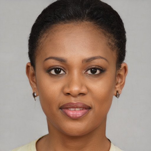 Joyful black young-adult female with short  brown hair and brown eyes