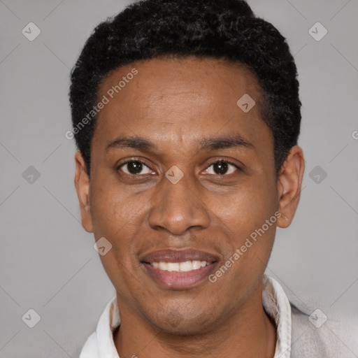 Joyful black adult male with short  black hair and brown eyes