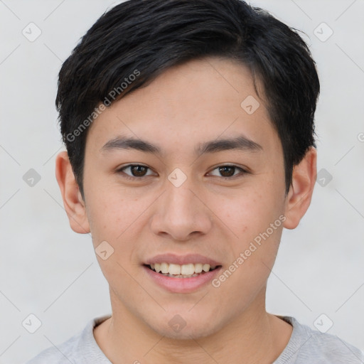 Joyful asian young-adult male with short  brown hair and brown eyes