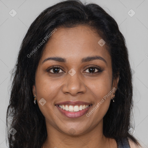 Joyful black young-adult female with long  brown hair and brown eyes