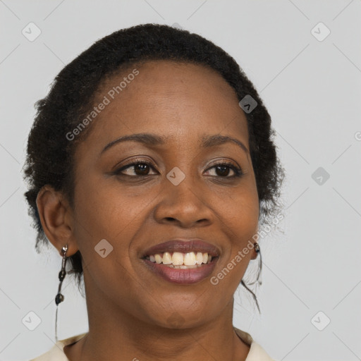 Joyful black young-adult female with long  brown hair and brown eyes