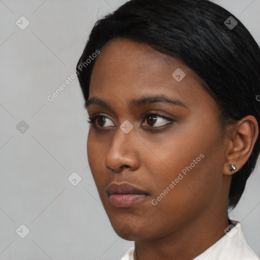 Neutral black young-adult female with short  black hair and brown eyes