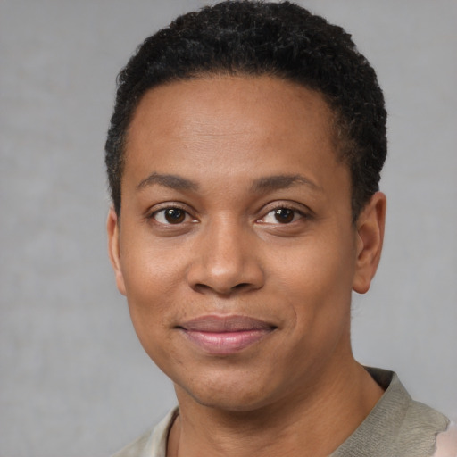 Joyful black young-adult female with short  black hair and brown eyes