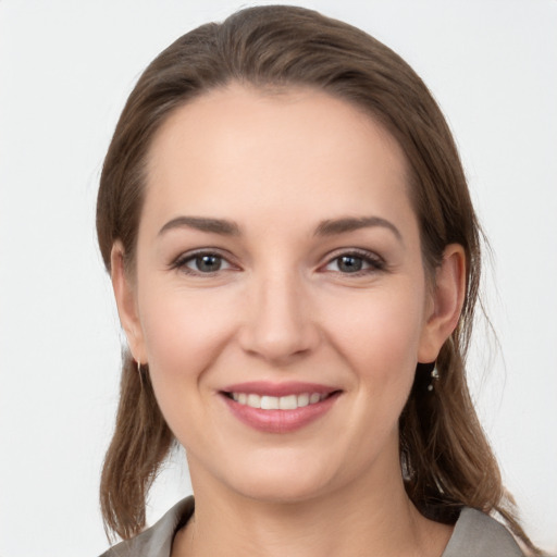 Joyful white young-adult female with medium  brown hair and grey eyes