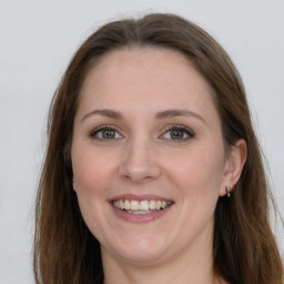 Joyful white adult female with long  brown hair and grey eyes