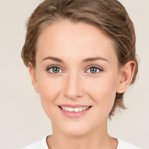 Joyful white young-adult female with medium  brown hair and green eyes