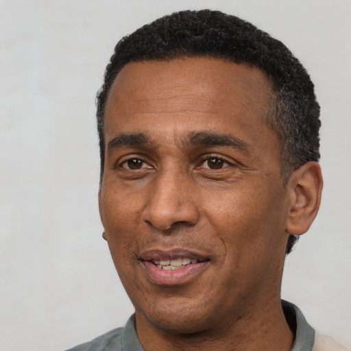 Joyful latino adult male with short  black hair and brown eyes