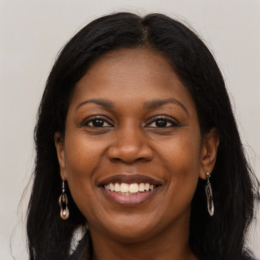 Joyful black young-adult female with long  brown hair and brown eyes