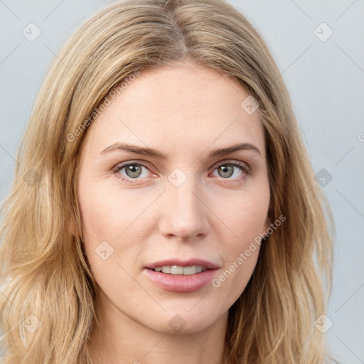 Joyful white young-adult female with long  brown hair and blue eyes