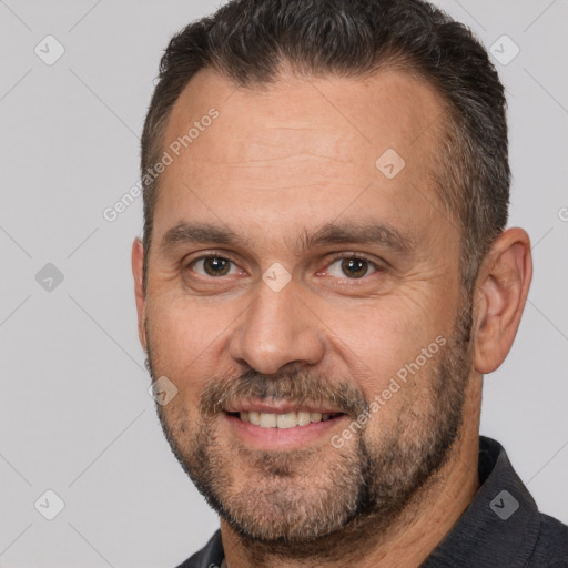 Joyful white adult male with short  brown hair and brown eyes