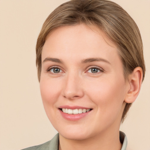 Joyful white young-adult female with medium  brown hair and grey eyes