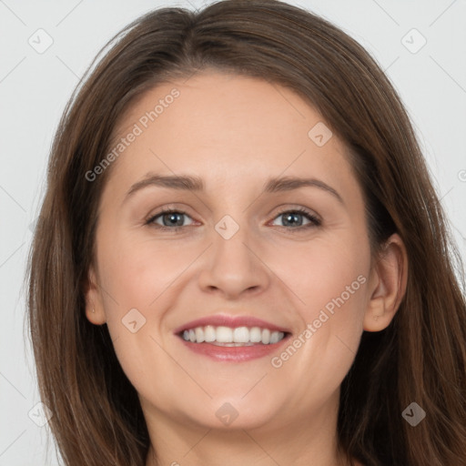 Joyful white young-adult female with long  brown hair and grey eyes