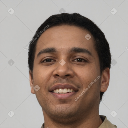 Joyful latino young-adult male with short  black hair and brown eyes