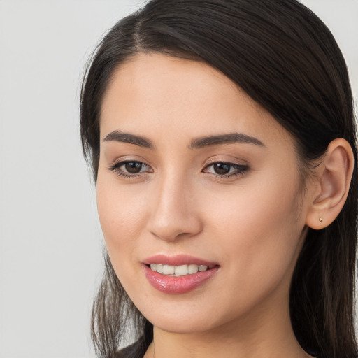 Joyful white young-adult female with long  brown hair and brown eyes