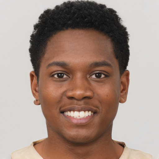 Joyful black young-adult male with short  black hair and brown eyes