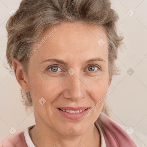 Joyful white adult female with short  brown hair and blue eyes