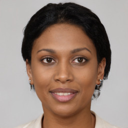 Joyful latino young-adult female with short  black hair and brown eyes