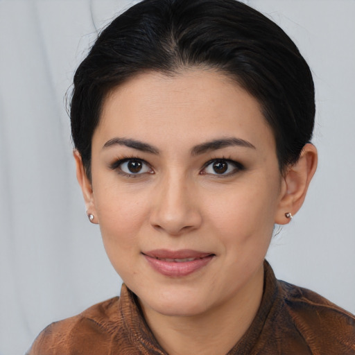 Joyful latino young-adult female with short  brown hair and brown eyes