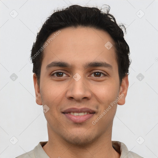 Joyful latino young-adult male with short  black hair and brown eyes