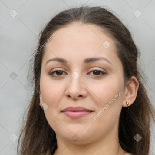 Joyful white young-adult female with long  brown hair and brown eyes