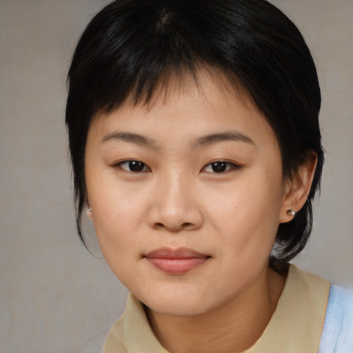 Joyful asian young-adult female with medium  brown hair and brown eyes
