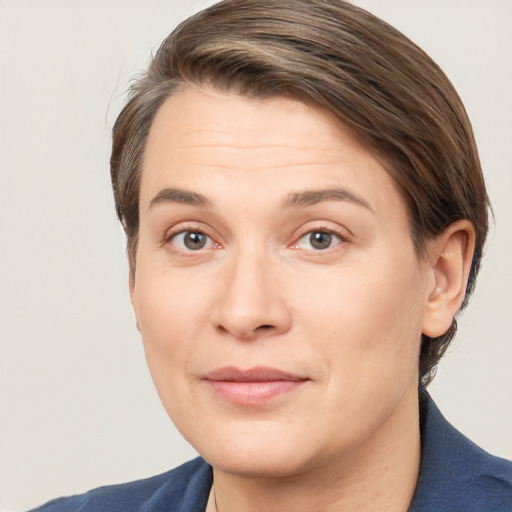 Joyful white young-adult female with short  brown hair and grey eyes