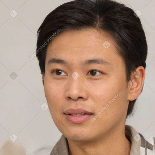 Joyful asian young-adult male with short  brown hair and brown eyes
