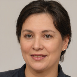 Joyful white adult female with medium  brown hair and brown eyes