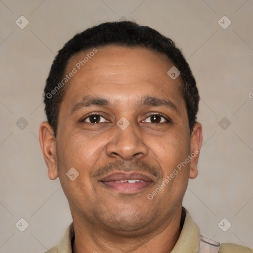 Joyful latino adult male with short  brown hair and brown eyes