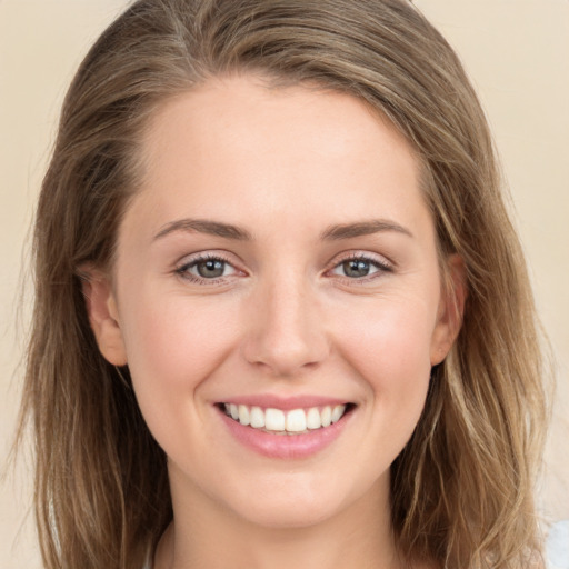 Joyful white young-adult female with long  brown hair and grey eyes