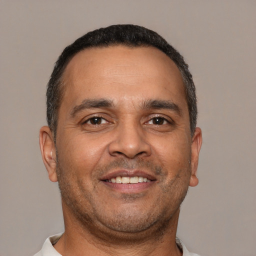 Joyful white adult male with short  brown hair and brown eyes