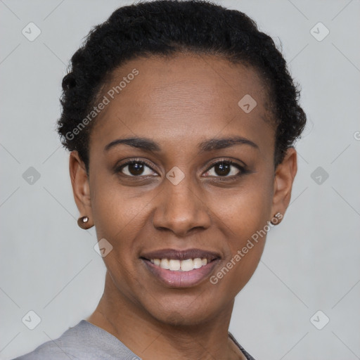 Joyful black young-adult female with short  black hair and brown eyes