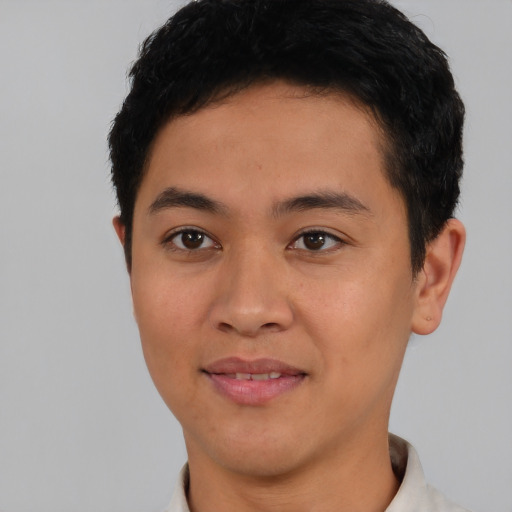 Joyful asian young-adult male with short  black hair and brown eyes