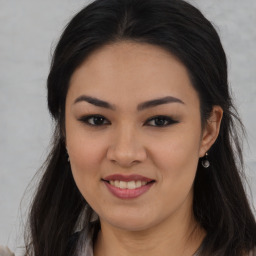 Joyful asian young-adult female with long  brown hair and brown eyes