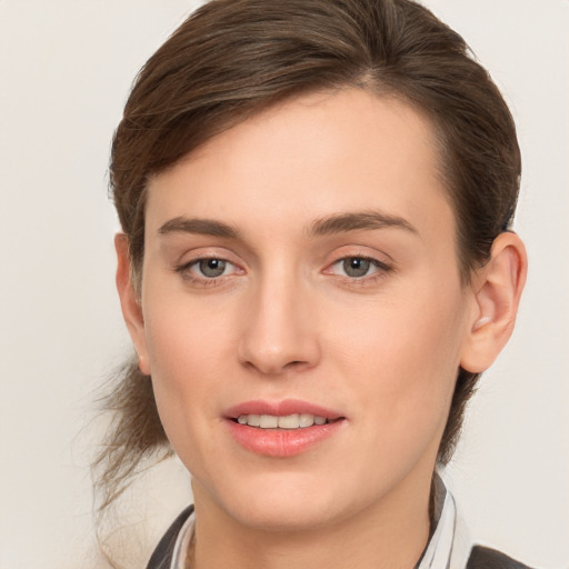 Joyful white young-adult female with medium  brown hair and grey eyes