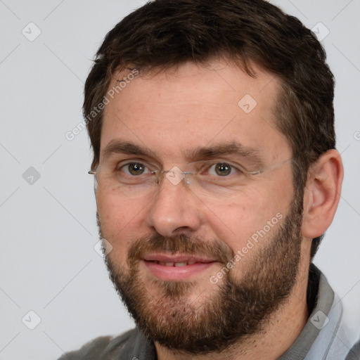 Joyful white adult male with short  brown hair and brown eyes