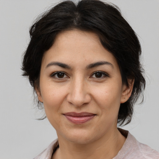 Joyful asian adult female with medium  brown hair and brown eyes