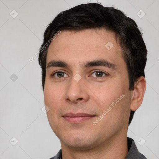 Joyful white young-adult male with short  black hair and brown eyes