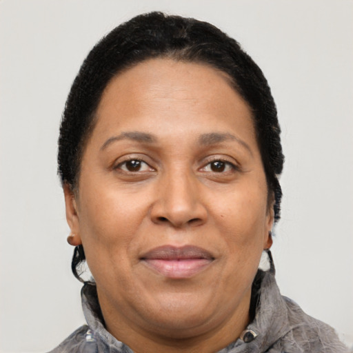 Joyful latino adult female with short  brown hair and brown eyes
