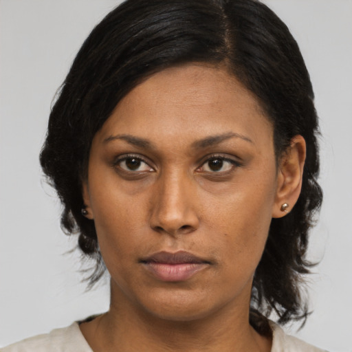Neutral black adult female with medium  brown hair and brown eyes